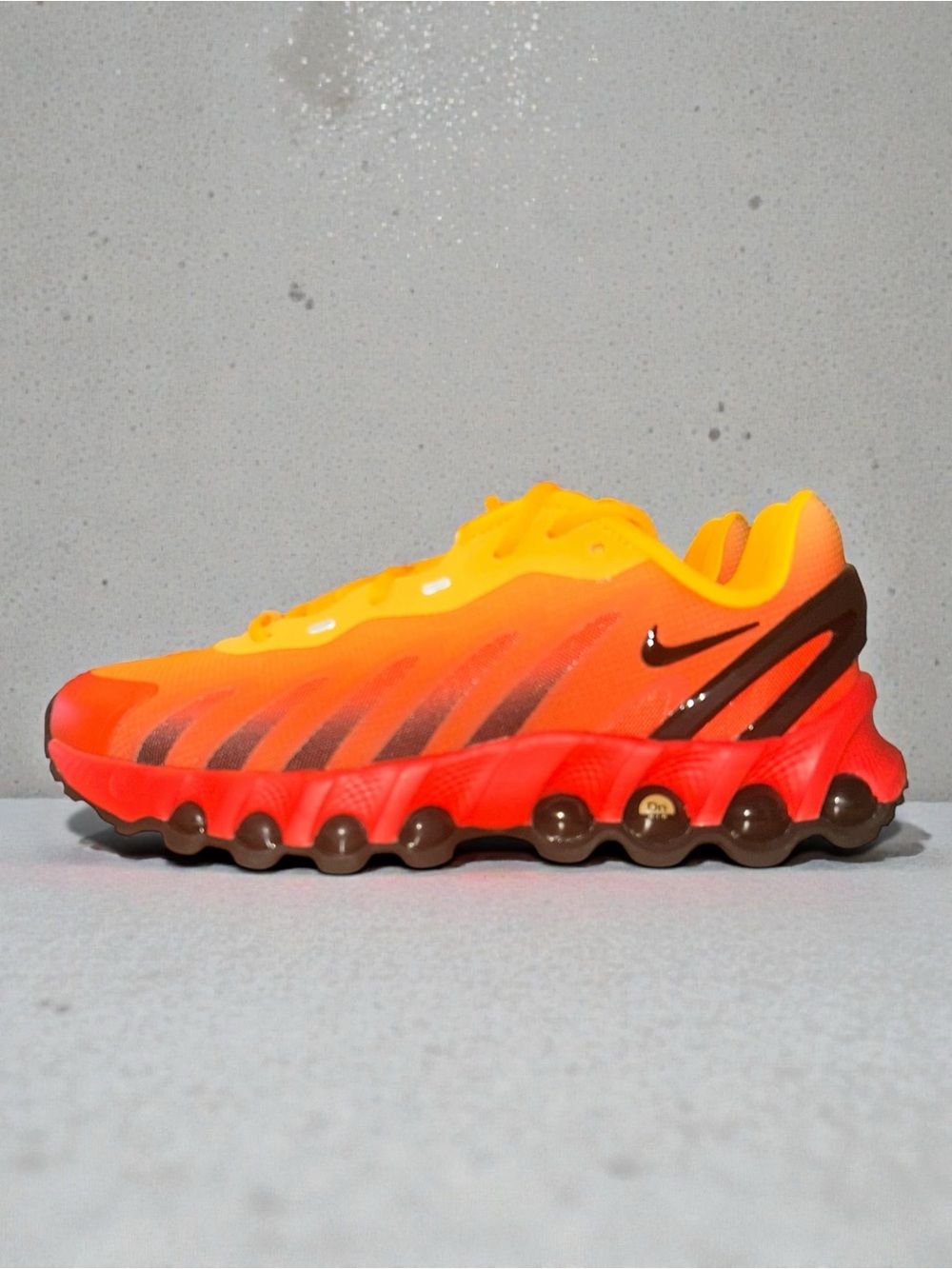 Nike Air Max DN8 
Orange and Red Gradient Athletic Sneaker
